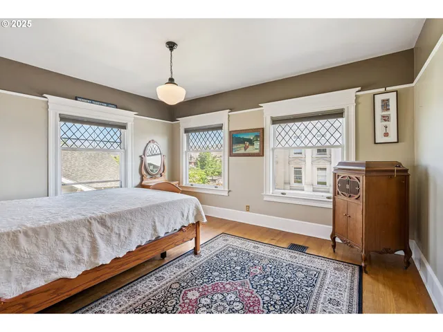 a spacious bedroom with a bed dresser and a window