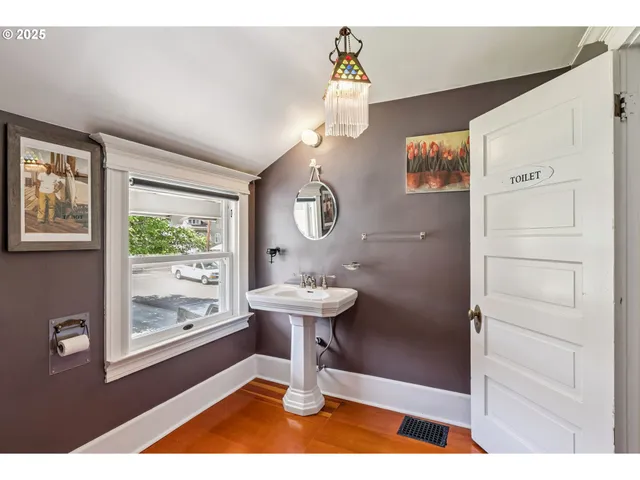 a bathroom with a sink a toilet and a window