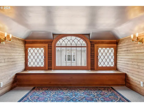 a bedroom with a bed and a large window