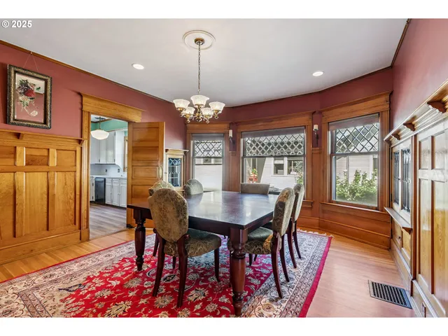 a view of a dining room with furniture wooden floor and chandelier