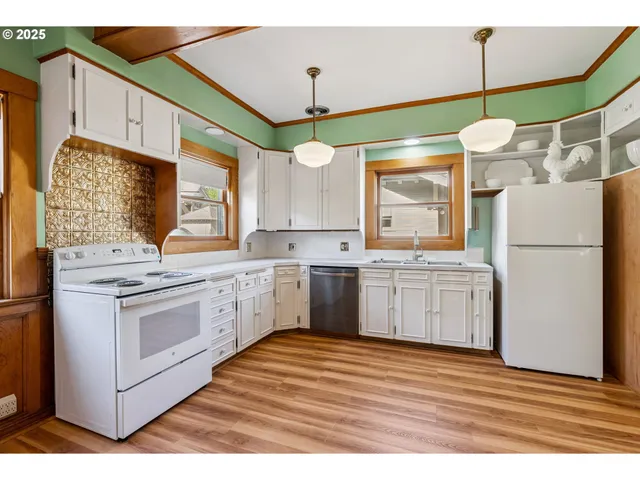 a kitchen with a sink window and cabinets