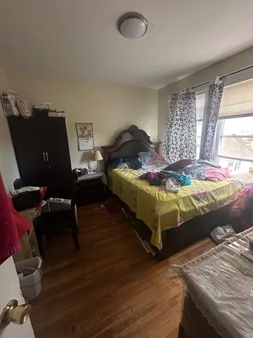 a bedroom with bed and window