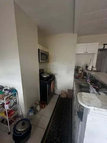 a kitchen with a sink stove and refrigerator
