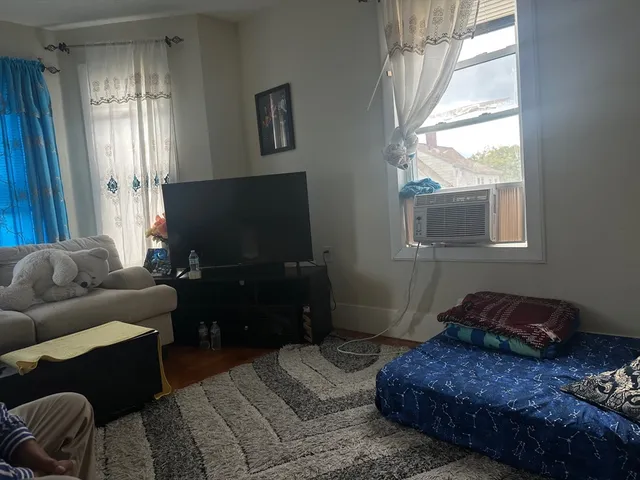 a bedroom with a bed and a television