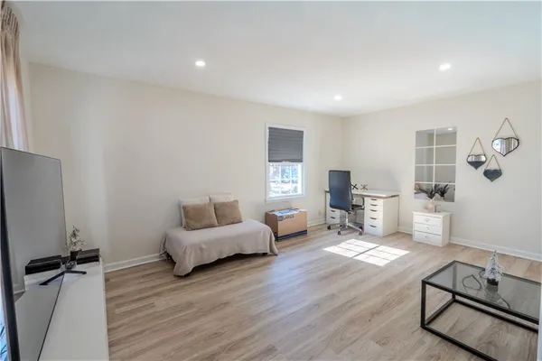 a living room with furniture and a wooden floor