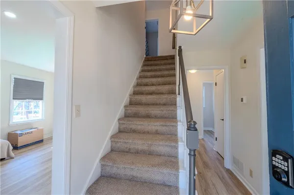 a view of a hallway with wooden floor and entryway