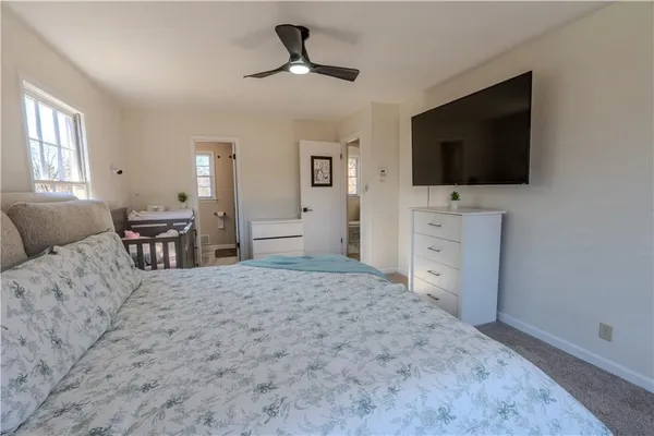 a bedroom with furniture and a flat screen tv