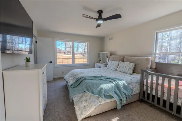 a bed sitting in a bedroom next to a window