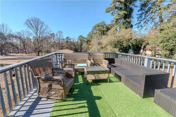 a view of a chairs and table on the deck
