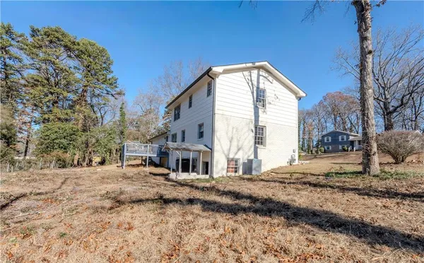 a view of a house with a house next to a yard