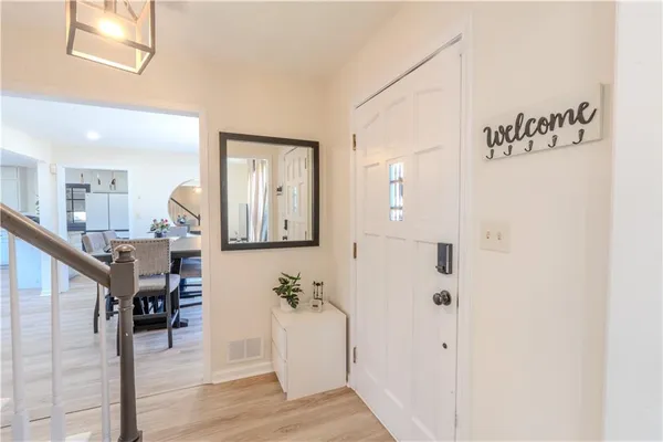 a view of a hallway with wooden floor windows and entryway