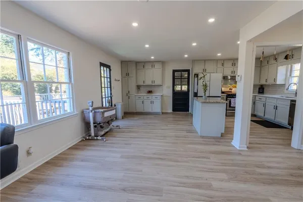 a living room with furniture and large windows