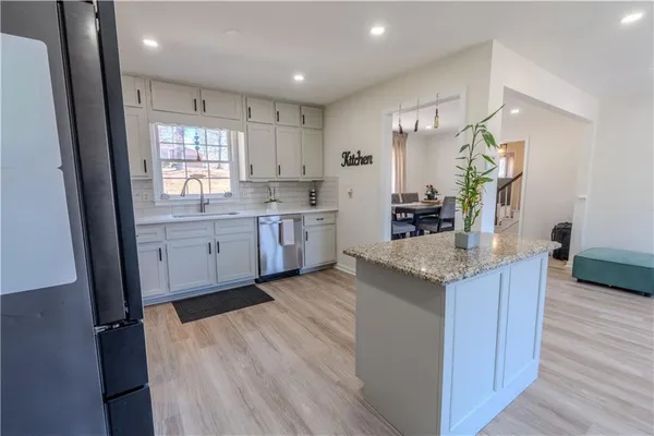 a kitchen with sink stove and refrigerator
