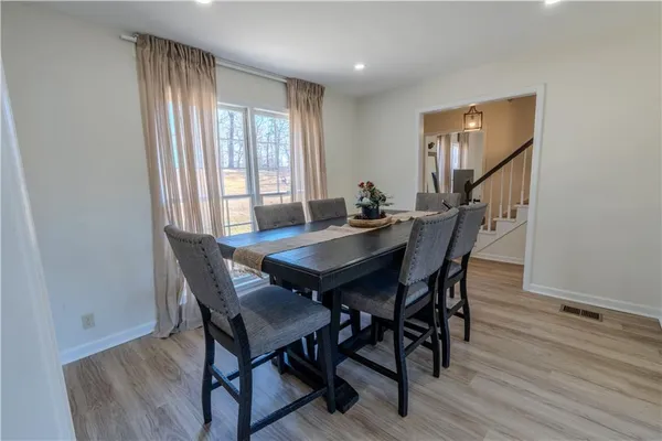 a view of a dining room with furniture and a window