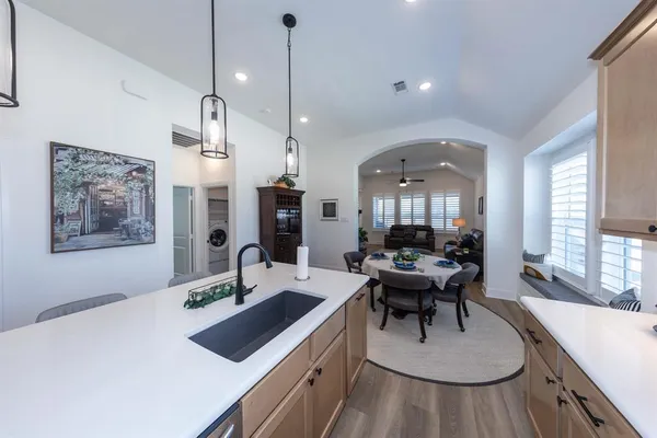 a view of a kitchen with a table and chairs