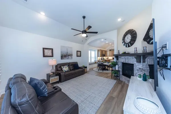 a living room with furniture a fireplace and a wall painting
