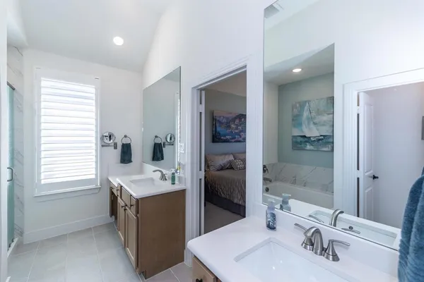 a bathroom with a sink double vanity and a mirror