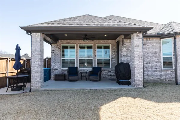a view of a house with a patio and a couch