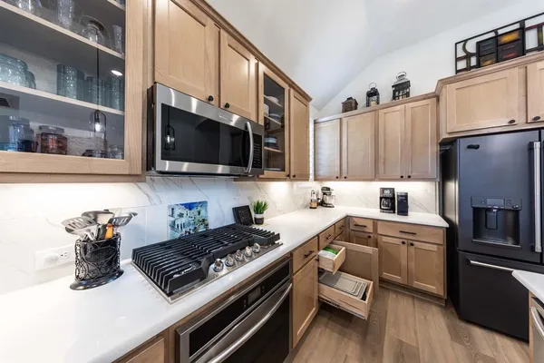 a kitchen with a stove a sink and a microwave