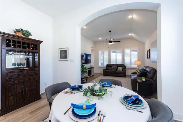 a kitchen with granite countertop a dining table and chairs