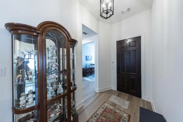 a view of front door with chandelier