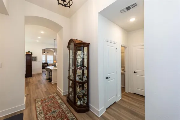 a view of a hallway and a livingroom with wooden floor