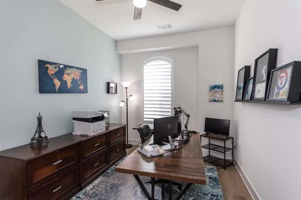 a view of a workspace with furniture and a window