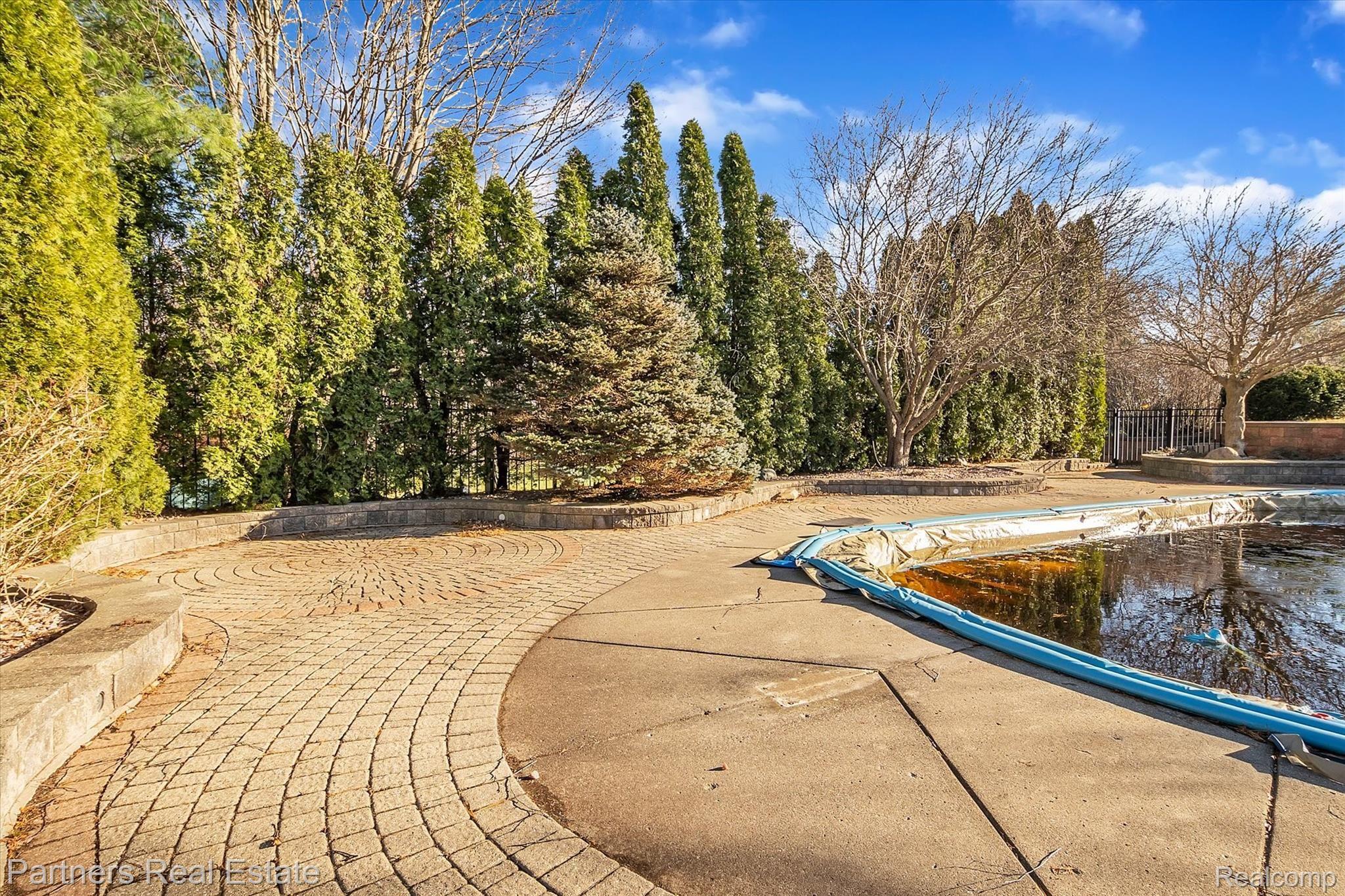 6400 Sharpe Road Fowlerville, MI 48836 - Photo 47 of 52 Beautiful landscaping provides lots of privacy around the Pool.