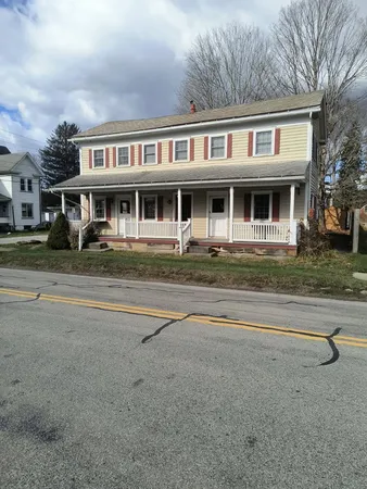 a front view of residential houses with yard