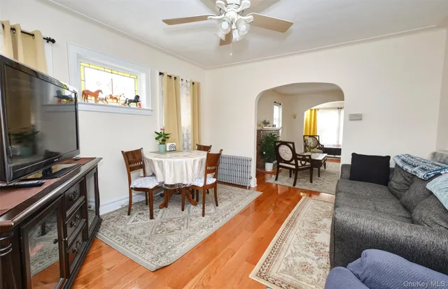 a dining room with furniture a rug and a flat screen tv