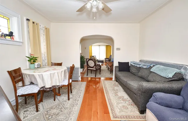 a living room with furniture and a dining table