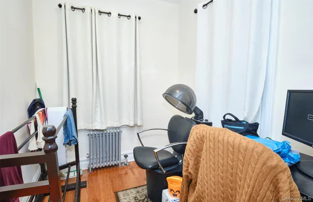 a view of a workspace with furniture and a window