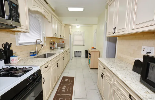 a kitchen with stainless steel appliances granite countertop a sink stove and cabinets