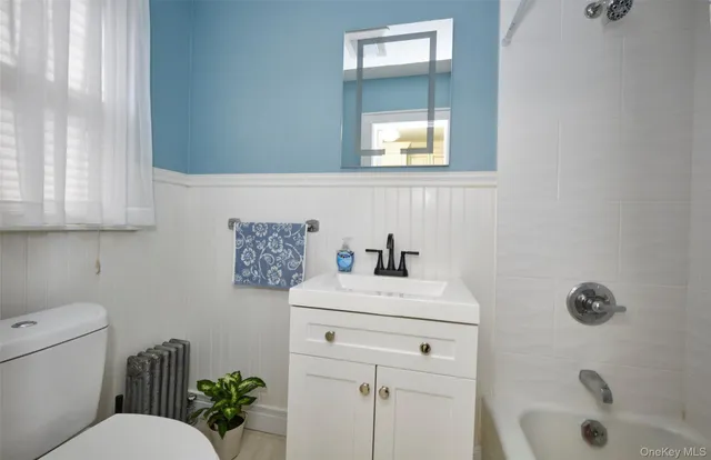 a bathroom with a sink toilet and tub
