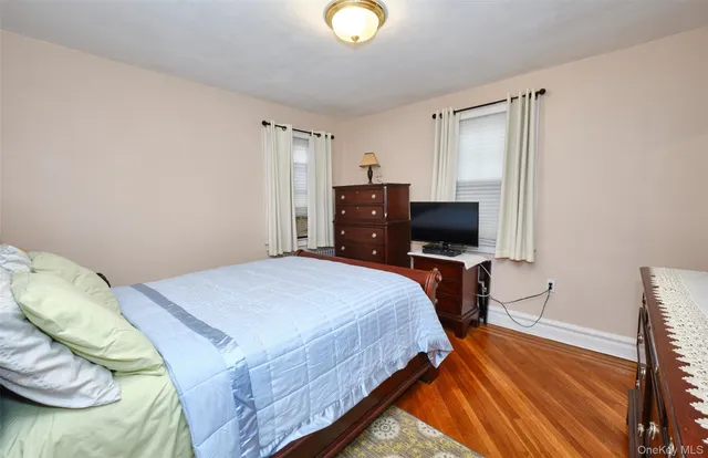 a bedroom with a bed and a television