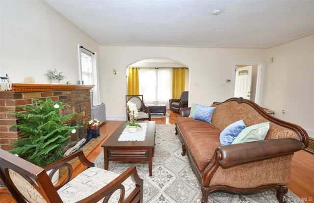 a living room with furniture fireplace and a large window