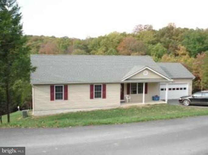 123 Martin Road Front Royal, VA 22630 - Photo 1 of 13 a front view of a house with a yard and garage