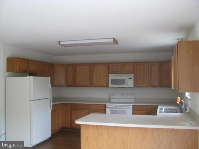 123 Martin Road Front Royal, VA 22630 - Photo 2 of 13 a kitchen with a refrigerator sink and cabinets