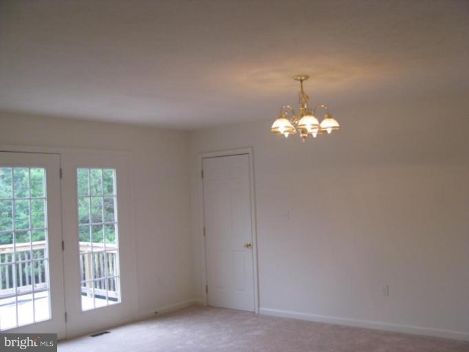 123 Martin Road Front Royal, VA 22630 - Photo 8 of 13 a chandelier fan and window in the room