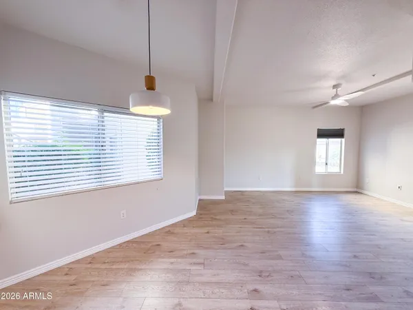a view of a livingroom with a window and wooden floor