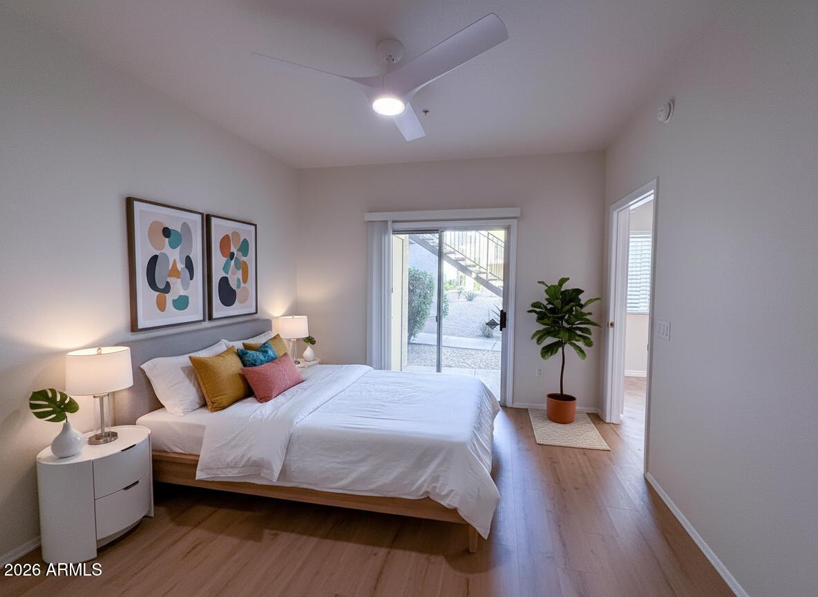 7101 West Beardsley Road, Unit 711 Glendale, AZ 85308 - Photo 15 of 33 a bedroom with a balcony a bed and a couch