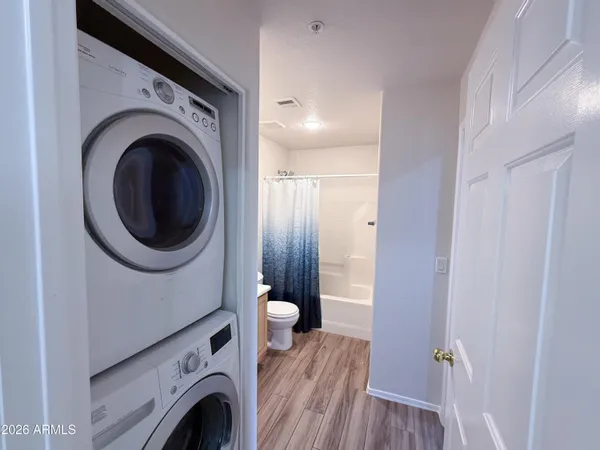 a view of a hallway with washer and dryer