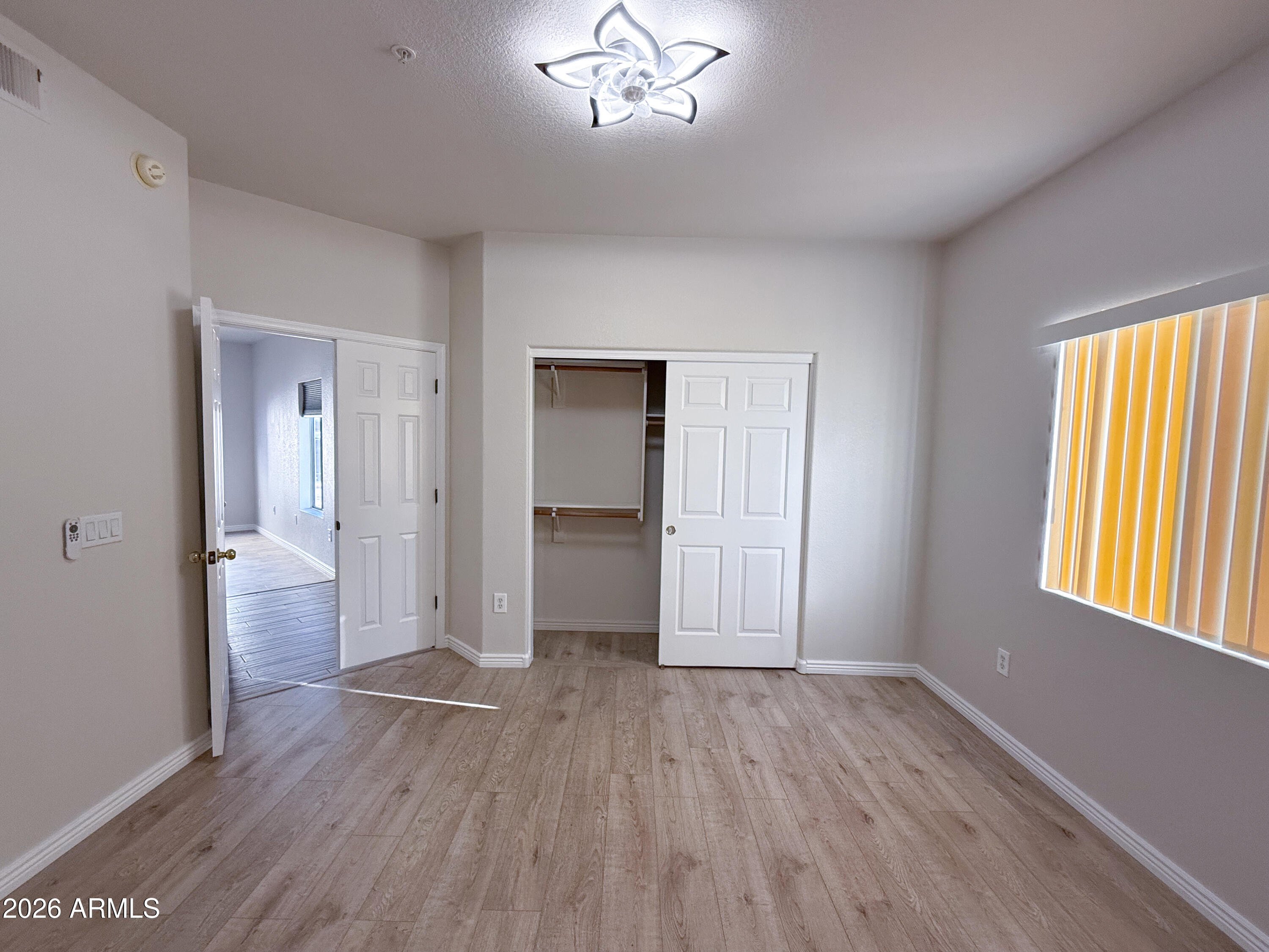 7101 West Beardsley Road, Unit 711 Glendale, AZ 85308 - Photo 24 of 33 a view of empty room with wooden floor and fan