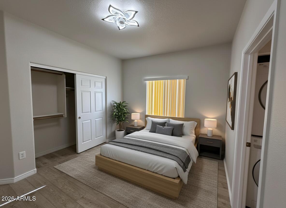 7101 West Beardsley Road, Unit 711 Glendale, AZ 85308 - Photo 26 of 33 a bedroom with a bed and a chandelier