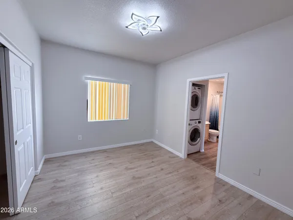 an empty room with windows and closet