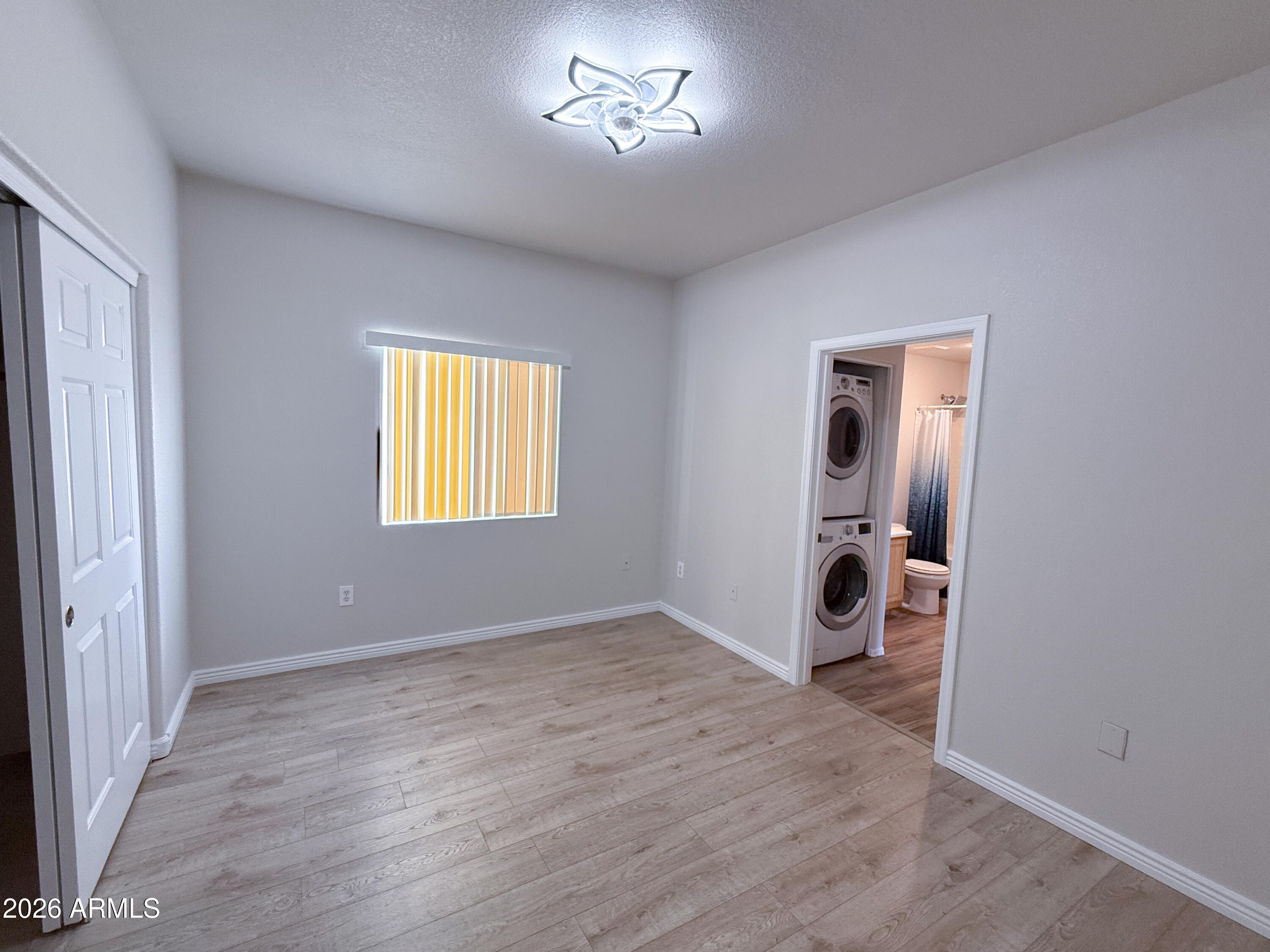 7101 West Beardsley Road, Unit 711 Glendale, AZ 85308 - Photo 27 of 33 an empty room with windows and closet