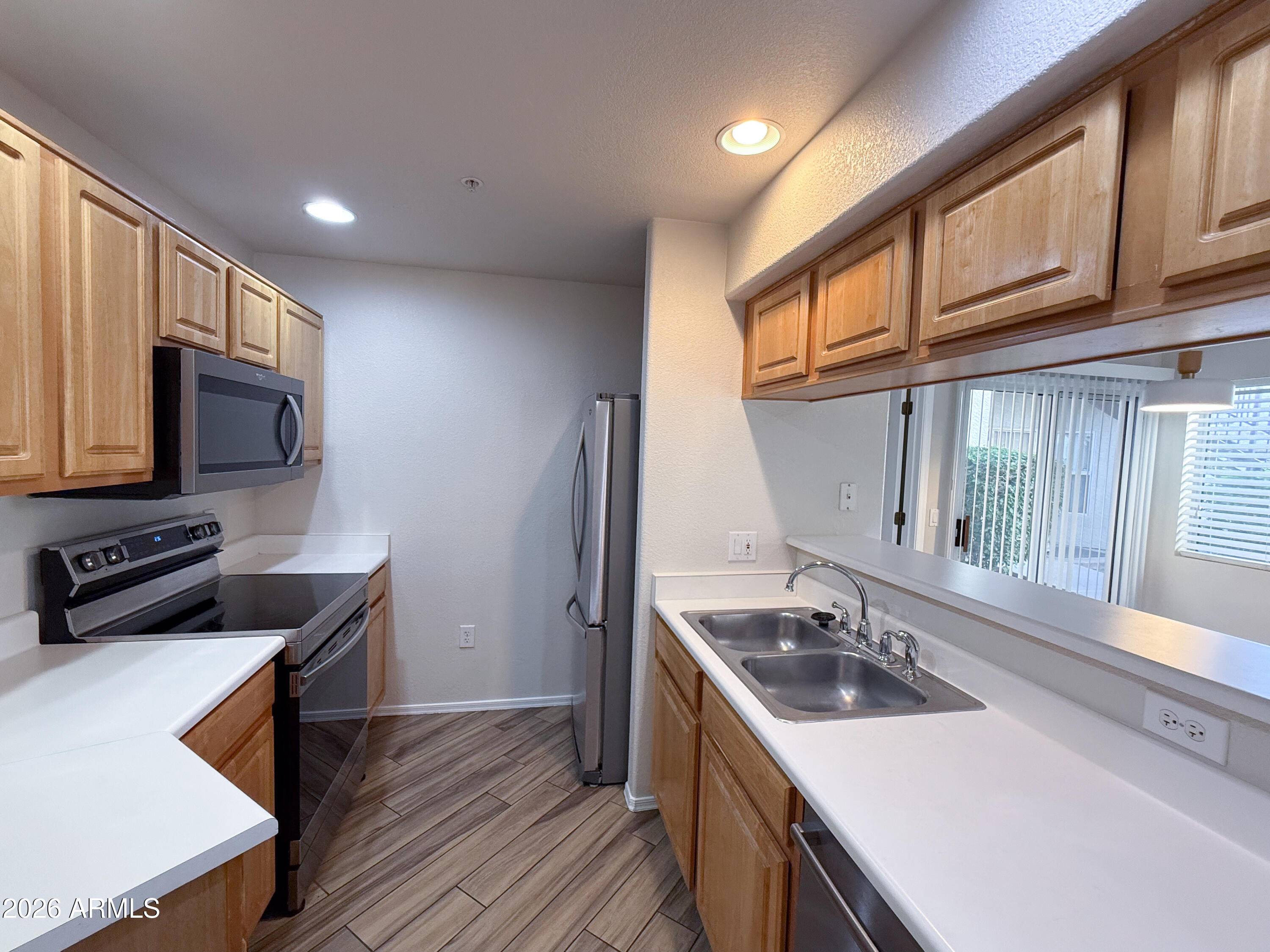 7101 West Beardsley Road, Unit 711 Glendale, AZ 85308 - Photo 3 of 33 a kitchen with a sink stove top oven and cabinets
