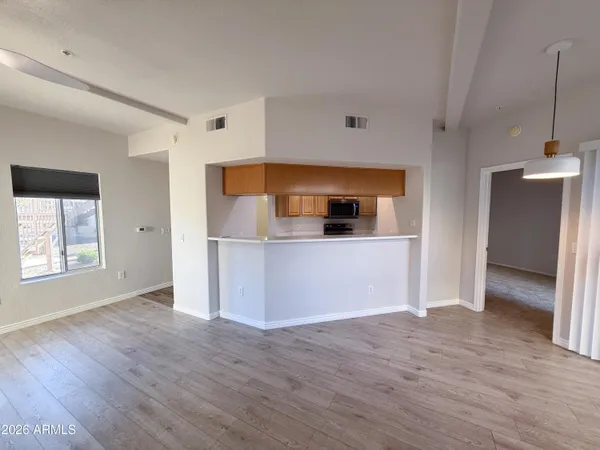 a view of a kitchen with a sink and a refrigerator