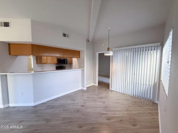 a view of a kitchen with a sink and cabinets