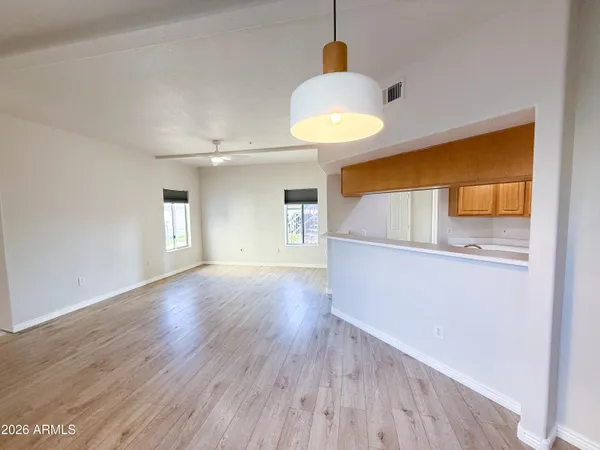 a view of empty room with wooden floor